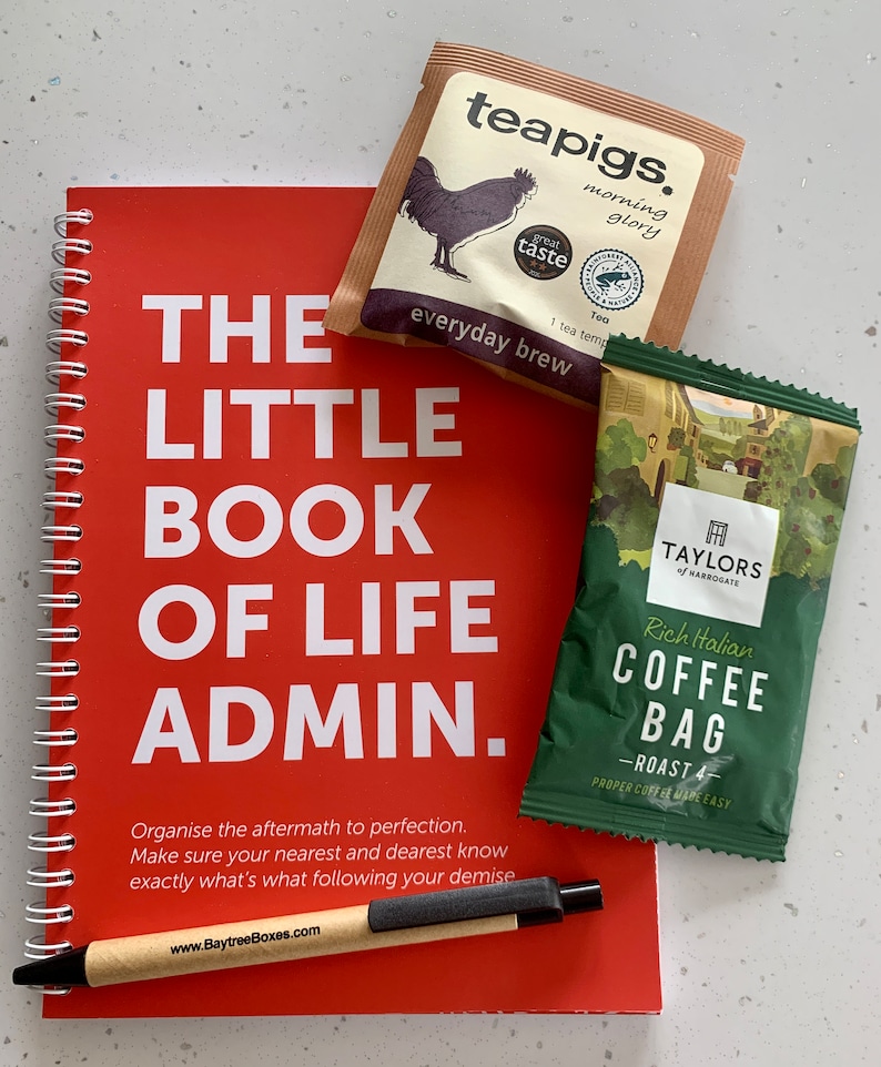 May include: A red spiral bound notebook with the title "The Little Book of Life Admin."  The notebook has a pen and two tea bags on top of it. One tea bag is brown with the text "teapigs. morning glory everyday brew" and the other tea bag is green with the text "TAYLORS of HARROGATE Rich Italian COFFEE BAG -ROAST 4- PROPER COFFEE MADE EASY".