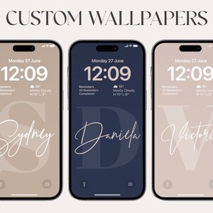 May include: Three iPhone mockups with custom wallpapers featuring a large initial letter in a white script font on a colored background. The first wallpaper is beige with the letter "S" for Sydney, the second is dark blue with the letter "D" for Daniela, and the third is beige with the letter "V" for Victoria.