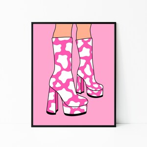 May include: Pink platform boots with a white cow print design. The boots have a thick heel and a platform sole.
