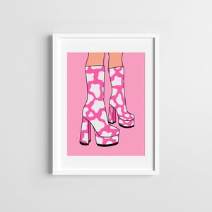 May include: A pair of pink platform boots with a white cow print design. The boots are on a pink background.