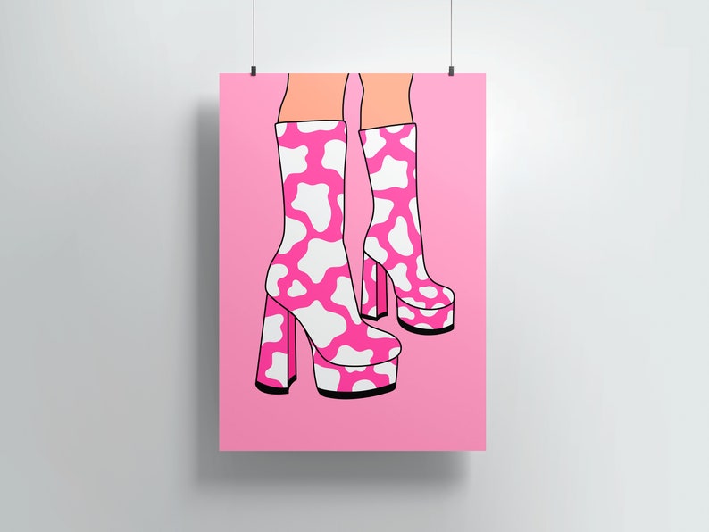 May include: A pair of pink platform boots with a white cow print design. The boots have a thick heel and a square toe.