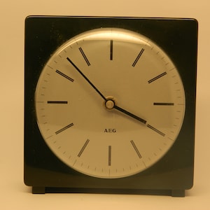 Vintage 1960&#39;s retro deco style AEG mantel clock-  This original 1960s AEG clock-stands freely on its wedge-shaped feet and is ideal for use