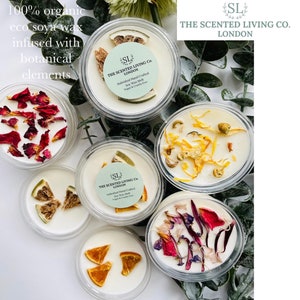 May include: Five small glass jars with lids filled with soy wax melts. Each jar contains different dried botanicals, including orange slices, rose petals, and dried flowers. The jars are labelled "The Scented Living Co. London" and "100% organic eco soya wax infused with botanical elements."