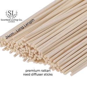 May include: A close-up of a bundle of natural, light brown rattan reed diffuser sticks. The sticks are 24 cm long and are labelled "premium rattan reed diffuser sticks".