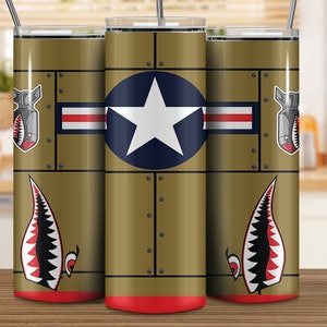 May include: Three stainless steel tumblers with a military theme. The tumblers feature a green background with a red stripe, a white star on a blue circle, and a shark tooth design.