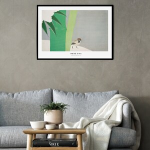 May include: A framed print of a sparrow perched on a branch with green leaves against a light gray background. The print has the Japanese text "雀" which means sparrow.