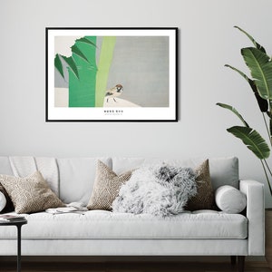 May include: A framed print of a minimalist Japanese-style illustration of a sparrow perched on a branch with green leaves. The print has a white background and the text "鳥は歌を歌う" in black.