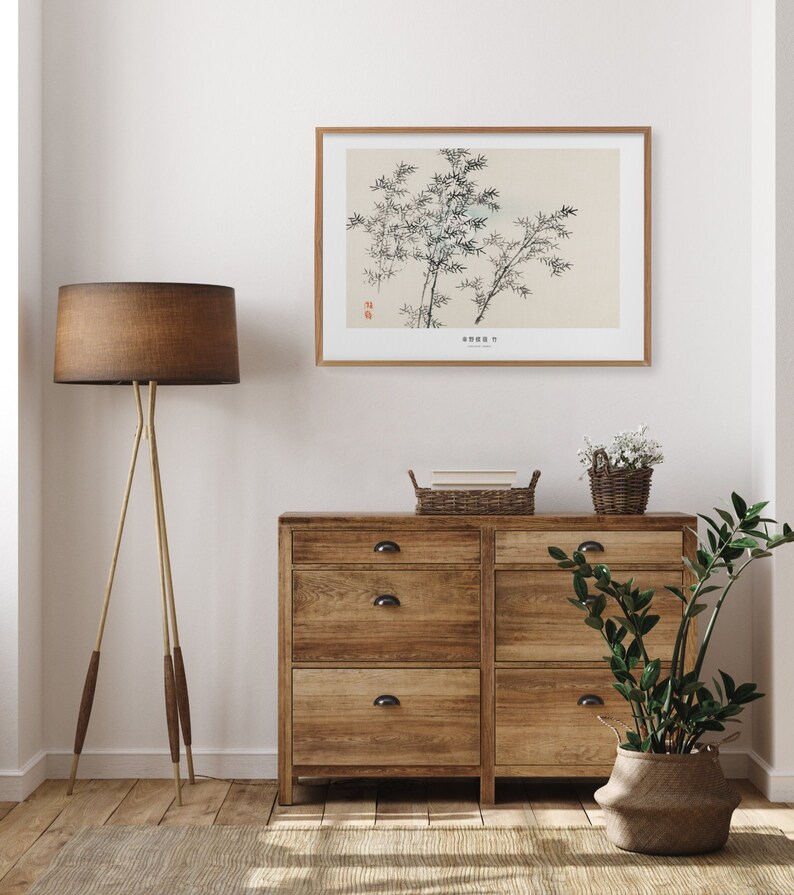 Puede incluir: Una c&oacute;moda de madera con seis cajones y tiradores negros. La c&oacute;moda est&aacute; en una habitaci&oacute;n con una pared blanca, una l&aacute;mpara marr&oacute;n, una impresi&oacute;n enmarcada de una ilustraci&oacute;n bot&aacute;nica en blanco y negro y una planta en maceta.