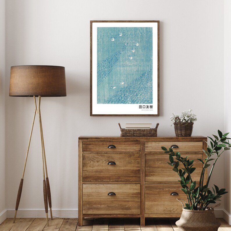 May include: A framed print of a blue and white Japanese woodblock print depicting a scene of birds flying over a body of water. The print is titled "田口玄樹" in Japanese.
