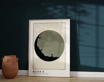 May include: A framed print of an abstract design in black and white, featuring a circle and a crescent moon shape. The print is titled "Moon" by Watanabe Soetsu (1885-1960).