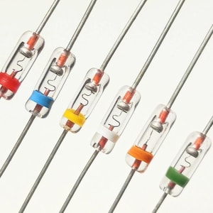 May include: Six axial lead electronic diodes arranged in a parallel diagonal row. Each component features a clear glass cylindrical body, a thin internal wire filament, and a distinct colored band in red, blue, yellow, white, orange, and green.