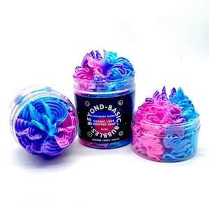 May include: Three jars of whipped soap with a pink and blue swirl. The jars are labelled "Beyond Basic Bubbles" and "Cosmic Love Whipped Soap" with a raspberry slush scent. The jars are 175g each.