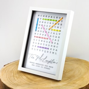 May include: A white framed word search puzzle with colorful letters spelling out the words "The McLaughlin's" and "Where memories are made and love is spread".