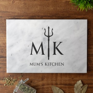 May include: White marble chopping board with a black trident design and the text "MK Mum's Kitchen".