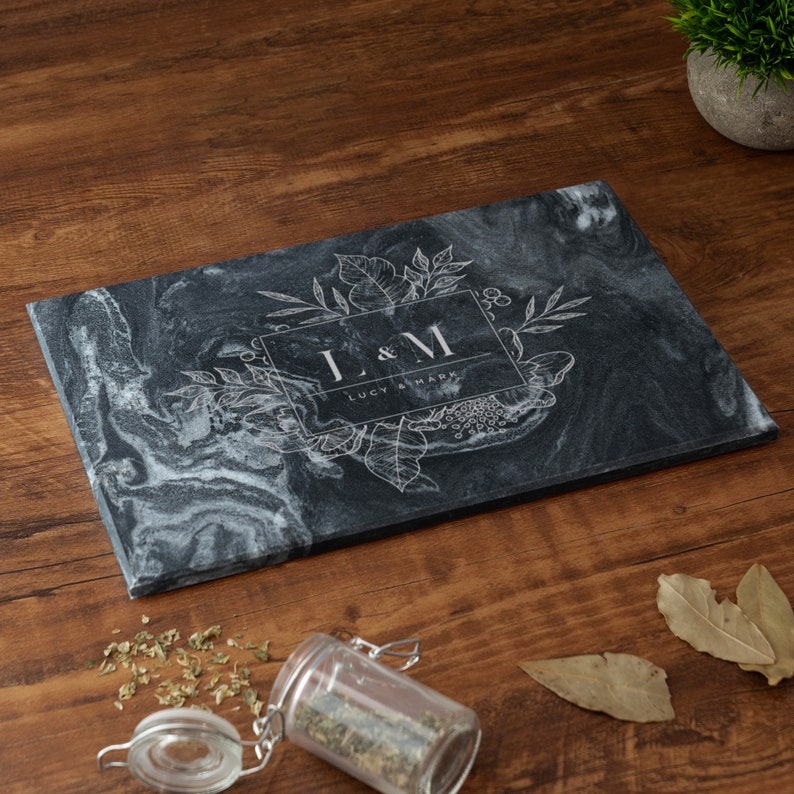 May include: Black marble cutting board with a white floral design and the initials "L & M" with the text "Lucy & Mark" underneath.