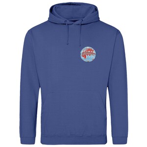 May include: A blue hoodie with a front pocket and a drawstring. The sweatshirt has a circular emblem on the chest with red, white, and blue details, resembling a globe. The garment is made of a soft material.