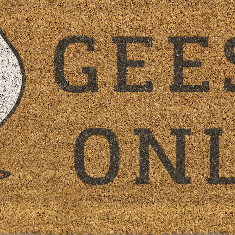 May include: A rectangular doormat made of natural coir fiber. The mat features the words "GEESE ONLY" in bold, black capital letters. A white goose graphic is visible on the left side of the mat.