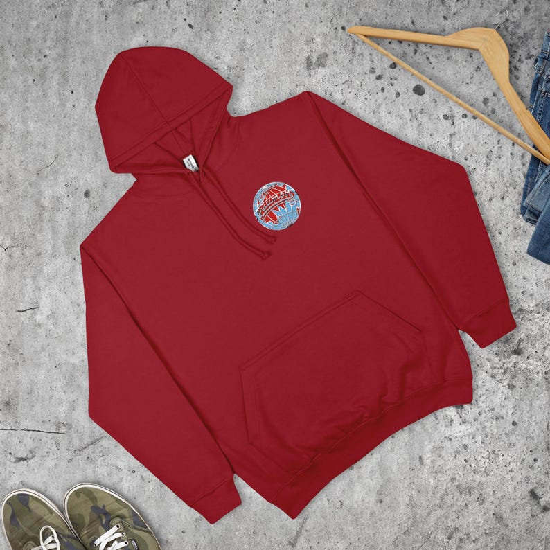 May include: A crimson hooded sweatshirt with a kangaroo pocket and a small embroidered globe design on the chest. The design includes the word "Adventures".