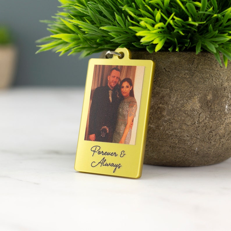 May include: Gold-colored metal keychain with a photo of a couple and the text "Forever & Always" engraved on the bottom.