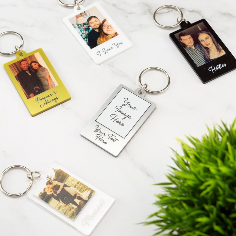 May include: Five different photo keychain designs.  The keychains are made of metal and plastic.  The keychains feature a variety of images and text, including "Forever & Always", "I Love You", "Hotties", "Your Image Here", and "Your Text Here".