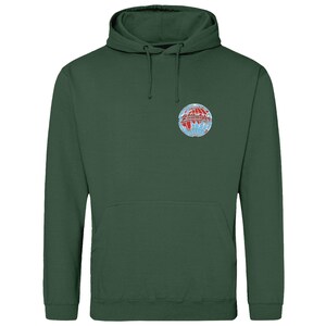May include: A dark green hoodie with a front pocket and a drawstring. The chest displays a circular emblem with a globe design in red, white, and blue. A casual, comfortable garment.