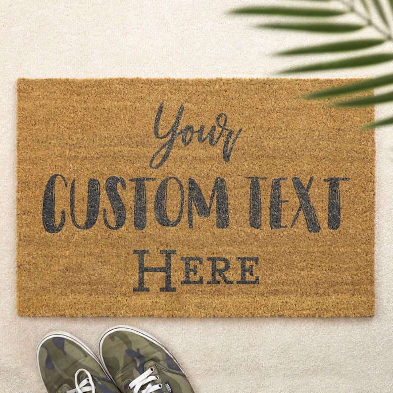 May include: A brown coir doormat with the text "Your Custom Text Here" in black lettering.