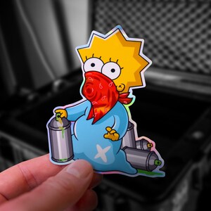 May include: A sticker featuring a cartoon character resembling Lisa Simpson from The Simpsons, wearing a red bandana and holding a spray paint can. The character is standing on a pile of spray paint cans.