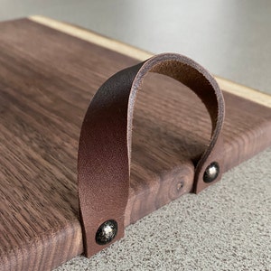 Add handles to your charcuterie board. We offer medium/dark brown leather handles.