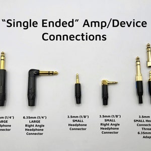 May include: A close-up of six different headphone connectors, including 1/4 inch and 1/8 inch sizes. The connectors are black with gold-plated tips. The text "Single Ended" Amp/Device Connections" is at the top of the image.