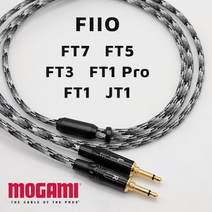 May include: A black and white braided audio cable with gold-tipped connectors. The cable features the brand name "MOGAMI" in red, and the text "FIIO" along with model numbers "FT7 FT5 FT3 FT1 Pro FT1 JT1" in black.