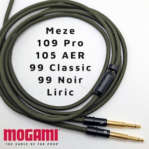 May include: A green cable with black connectors and gold-plated plugs. The cable is labeled "MOGAMI THE CABLE OF THE PROS". The cable is compatible with Meze 109 Pro, 105 AER, 99 Classic, 99 Noir, and Liric headphones.
