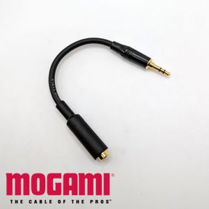 May include: A black Mogami audio cable with gold-plated 1/4 inch female and 1/8 inch male connectors. The cable is coiled and the Mogami logo is visible on the cable.