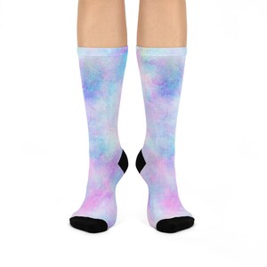 Può includere: Un paio di calzini colorati con un motivo tie-dye in tonalità rosa, blu e viola. I calzini hanno accenti neri sulla punta e sul tallone.