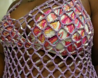 May include: A purple crochet top with a floral pattern and silver beads. The top is made of a delicate, open-weave fabric.