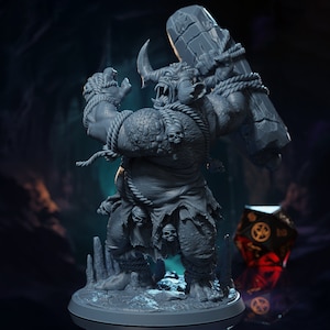 May include: A gray, detailed miniature figurine of a monstrous creature with horns, holding a large rock in its right hand. The creature is wearing a loincloth and has a rope tied around its waist. The figurine is standing on a gray base.