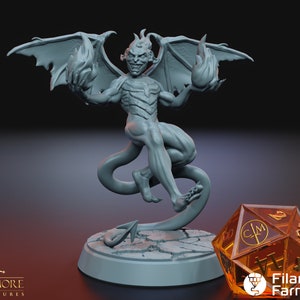 May include: A gray 3D printed miniature of a demon with wings, a tail, and flames in its hands. The miniature is standing on a circular base with a cracked surface. A clear orange dice with black markings is in the foreground.