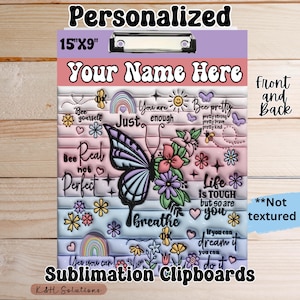 May include: A personalized clipboard with a metal clip, measuring 15" x 9". The design features a butterfly, flowers, and inspirational quotes on a pastel background. Text includes "Your Name Here" and "Sublimation Clipboards".