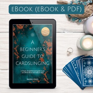 May include: An ebook titled "A Beginner's Guide to Cardslinging" displayed on a tablet. The cover features teal and gold accents. A deck of blue cards, a ring, and candles are arranged around the tablet. The text "EBOOK (EBOOK & PDF)" is at the top.