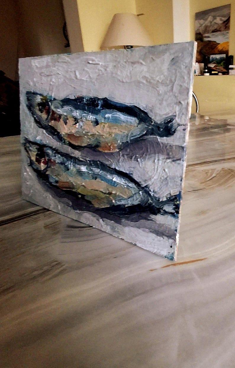 May include: Oil painting on canvas depicting two fish. The fish are painted in shades of blue, white, and brown against a textured, light gray background. The artwork is displayed on a white-edged square canvas.