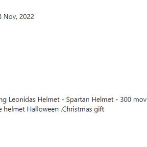 May include: A gold-colored Spartan helmet with a black plume, displayed on a stand. The helmet is a replica of the Great King Leonidas helmet, suitable for Halloween or as a Christmas gift.