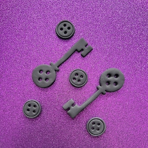The key to the other side, the looking charm, creepy hand, and/or buttons