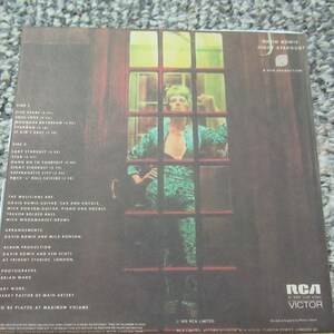 May include: An album cover for David Bowie's Ziggy Stardust, with a photo of Bowie in a teal jumpsuit. The tracklist and credits are visible. The RCA Victor logo is at the bottom. Measurements are not applicable.