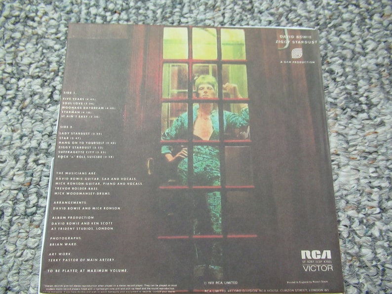 May include: An album cover for David Bowie's Ziggy Stardust, with a photo of Bowie in a teal jumpsuit. The tracklist and credits are visible. The RCA Victor logo is at the bottom. Measurements are not applicable.