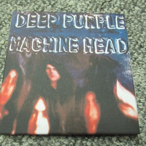 May include: A vintage CD case with a faded image of a band. The case is blue and white with the text "Deep Purple Machine Head" in silver lettering.