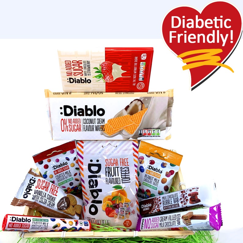 May include: A wooden basket filled with various sugar-free snacks, including chocolate wafers, fruit-flavored candies, and chocolate-covered treats. The basket is labeled "Diabetic Friendly!" in a red heart shape.