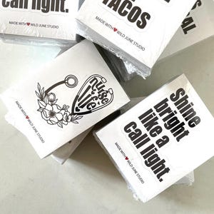 Stickers with various phrases and designs, including a heart-shaped sticker and a sticker with the phrase "Shine bright like a call light."