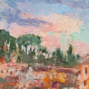 May include: Impasto oil painting of a cityscape at sunset. The sky is a blend of pink, blue, and lavender hues, with textured brushstrokes. Buildings with orange and brown roofs are visible below green trees. The artwork evokes a sense of warmth and tranquility.