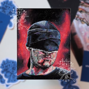 Peut inclure: Une impression d'art rectangulaire représentant le portrait d'une silhouette portant un bandeau sombre et texturé sur les yeux. L'arrière-plan est un mélange vibrant et tourbillonnant de rouge profond et de noir, avec un visage aux traits peints.