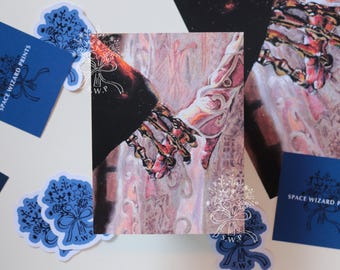 May include: A rectangular art print featuring a detailed illustration of two hands reaching toward each other, one dark and skeletal, the other light and ethereal, surrounded by blue square cards and stickers with the text SPACE WIZARD PRINTS.