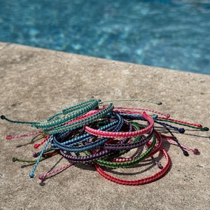 2 WOVEN WATERPROOF bracelets. Set of 2. Surf bracelets. Couple bracelets. Square knots. Charms. REVERSIBLE, stackable, adjustable bracelets.